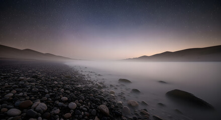 Serene Misty Night Landscape of a Rocky Shoreline Under a Starry Sky