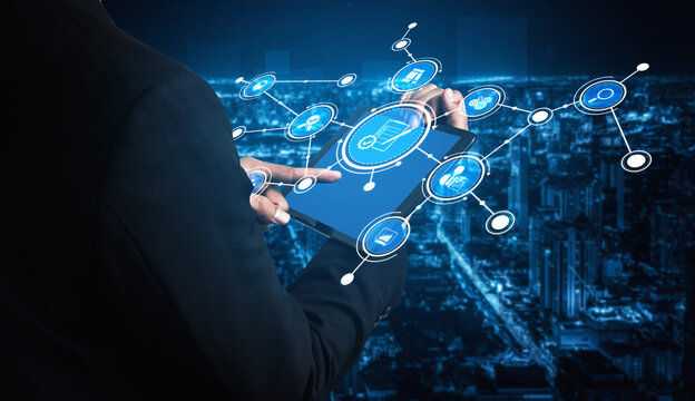 A business professional interacts with a tablet displaying digital network connections against a vibrant city skyline, showcasing the essence of technology and innovation. Tessel