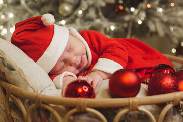 Little girl lays on a holiday background in Santa costume