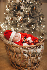 Little girl lays on a holiday background in Santa costume