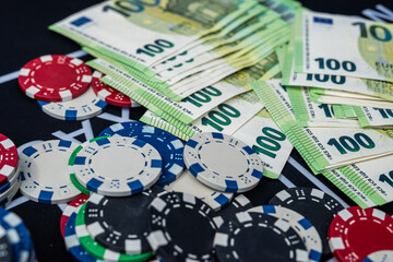 Euro banknotes and poker chips close up representing casino games, risk and gambling wealth