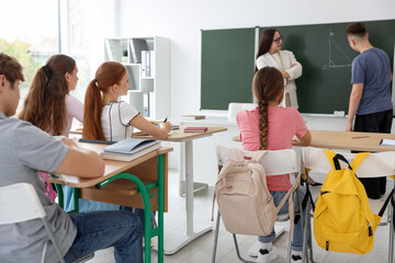 Teacher and students during lesson in classroom