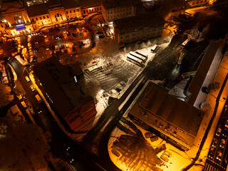 Vertical Aerial Night View of Snowy Street and Park Near Tarnów Station