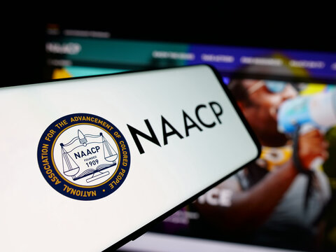 Stuttgart, Germany - 11-19-2025: Smartphone with logo of US colored people association NAACP on screen in front of website. Focus on left of phone display.