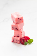 Raspberry candy with pieces of freeze-dried raspberries. Close-up	