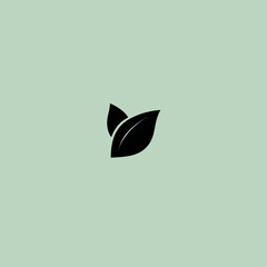 Minimalist black leaf symbol on pale green background for environmental concept