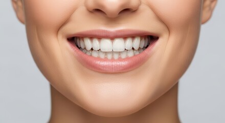 Obraz premium Close-up of a smiling young caucasian female showing healthy teeth