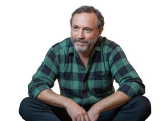 Mature man in plaid shirt sitting relaxed and smiling, looking away