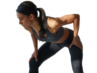 Young woman resting, hands on knees, after an intense workout