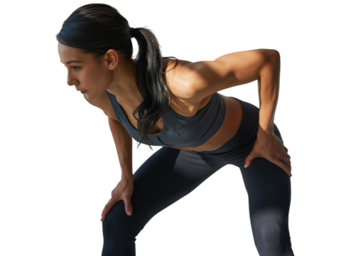 Young woman resting, hands on knees, after an intense workout