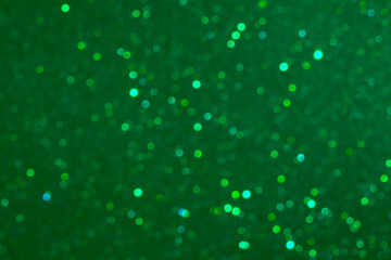 Emerald glittery bokeh background with sparkling lights for festive scenes and dreamy mood