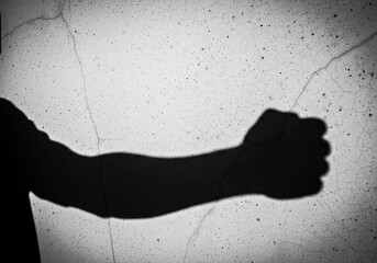Shadow of fist threatening violence on dirty wall | boxing, boxer, fighting, punch, athlete, gloves, training, action, combat sport, strength
