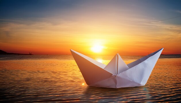 paper boat at with sunrise behind fresh new start