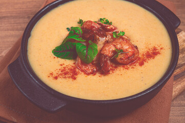 pumpkin cream soup with shrimp, herbs and spices, homemade, no people,