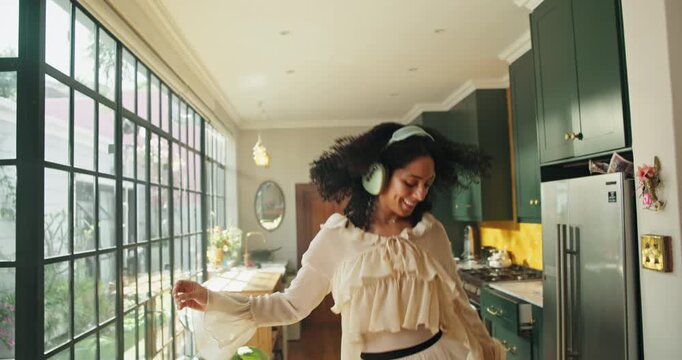 Headphones, dancing and happy woman on couch with music, streaming album and online radio song. Audio tech, energy and person in home with movement for rhythm, playlist and track listening on weekend