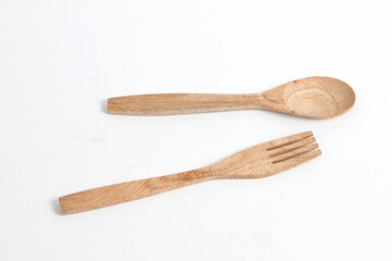 Spoons and forks made of teak wood isolated on white background. Traditional cutlery with a rustic feel