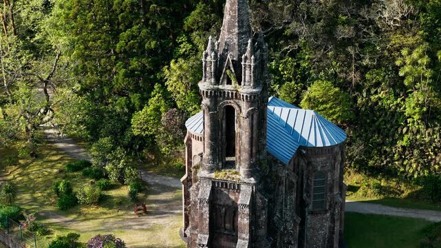 Aerial view of abandoned church, old chapel by the lake Furnas, Capela de Nossa Senhora das Vitorias, Azores, Portugal