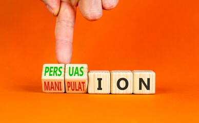Persuasion or manipulation symbol. Concept words Persuasion and Manipulation on wooden cubes. Beautiful orange background. Psychologist hand. Psychology persuasion manipulation concept. Copy space.