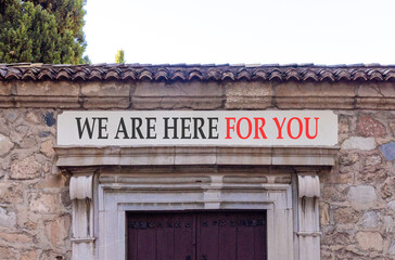 Support, help and we are here for you symbol. Concept words We are here for you on beautiful white marble sign plate. Beautiful stone wall background. Business we are here for you concept. Copy space.