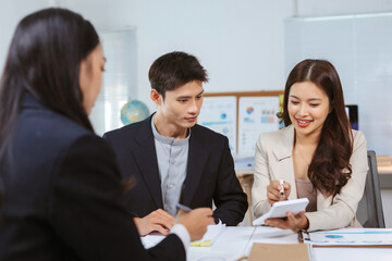 Business colleagues discussing financial strategy and calculating figures in a modern office meeting, focusing on teamwork and planning