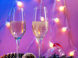 Two glasses of champagne on a bright festive Christmas background