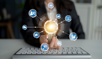 A professional woman in business attire holds a glowing sphere surrounded by digital icons, symbolizing technology and innovation in a modern workspace, emphasizing connectivity and growth. Crux