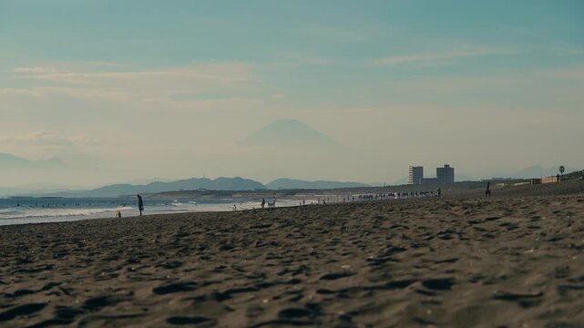 Static distant view of Mount Fuji and calm sea from Chigasaki, Japan