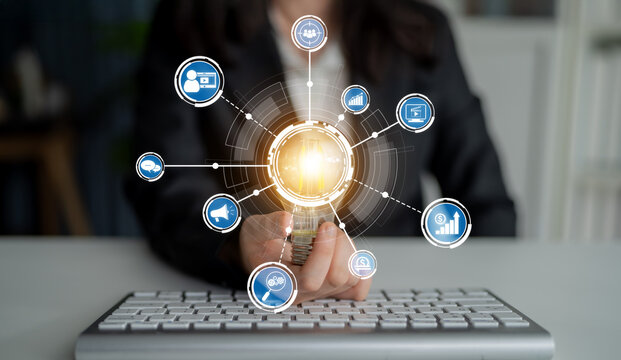 A professional woman in business attire holds a glowing sphere surrounded by digital icons, symbolizing technology and innovation in a modern workspace, emphasizing connectivity and growth. Crux