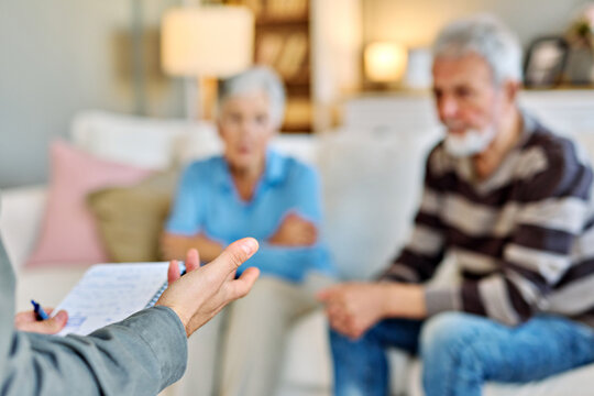 Mature couple consultation session with health therapiest or doctor at home or in doctor's office, or an insurance real estate agent