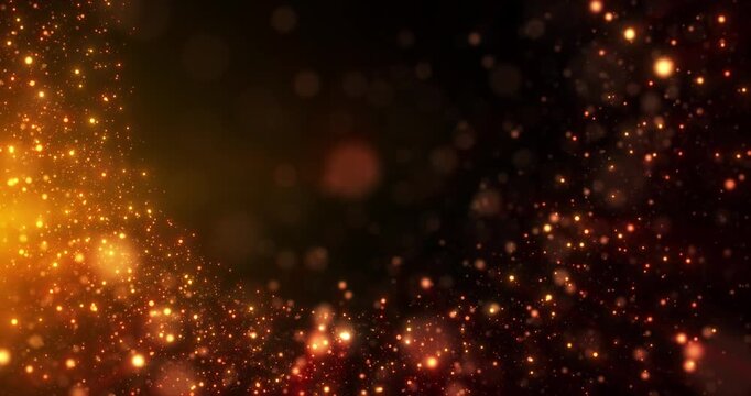 Animation concept of flying gold and orange particles with bokeh effects and glowing particles rising against a dark background. Animation footage.
