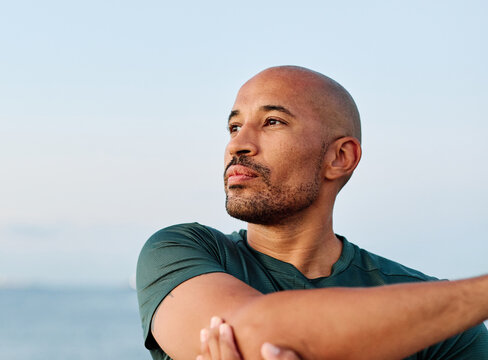 Portrait os a happy bhandsome black  man exercising and stretching outdoors - Powered by Adobe