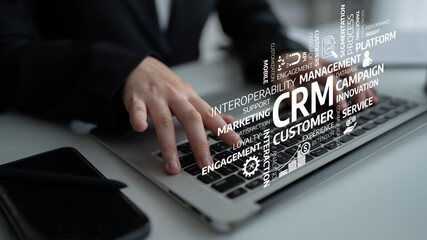 A business professional is engaged with a laptop in a modern workspace, where various CRM concepts emerge, highlighting the focus on customer management strategies. Tessel