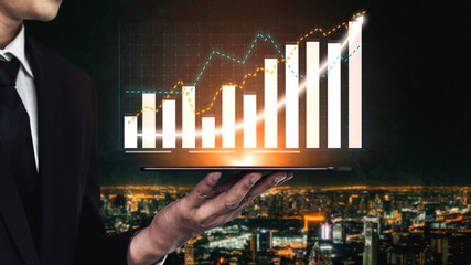 A businessman is presenting graphs and data on a tablet while overlooking a bustling city at night. This image represents growth, success, and financial strategies. Impute