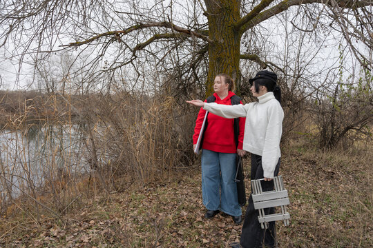 Artist and model at riverside: preparing to paint a live outdoor portrait