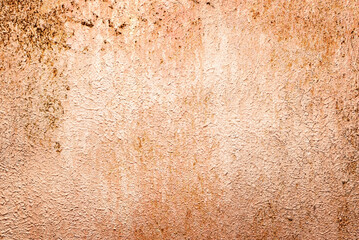 Peeling paint on rusty metal surface with rough texture and warm brown-orange tones. Ideal for...
