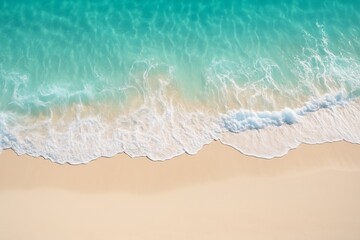 Serene beach with clear turquoise water gently lapping against shore, relaxation and contemplation. Contrast between sand and blue-green waves. Aerial view. Background for marketing tourism products