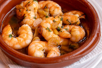 Garlic shrimp in a clay pot, made with garlic, olive oil, and cayenne pepper. A popular Spanish appetizer.