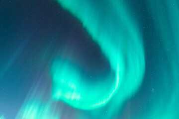 Aurora borealis creating vibrant green light across the night sky in Sweden