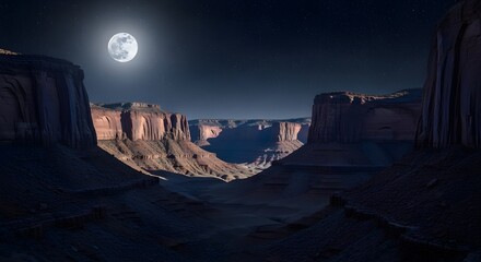 Night in monument valley landscape under full moon casting shadows