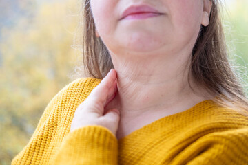 Closeup mature woman’s neck, natural wrinkles, double chin, realistic aging skin texture, age-related skin changes, care anti-aging procedures, skincare awareness, natural aging signs, body positivity