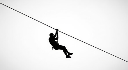 Silhouette of a person zip-lining adventure