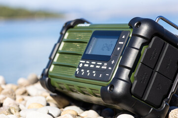 Rugged Handheld Radio With Digital Display On Pebble Ground For Fieldwork