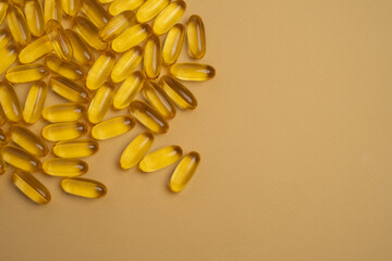 Pile of golden fish oil capsules for health and nutrition. Essential Omega-3