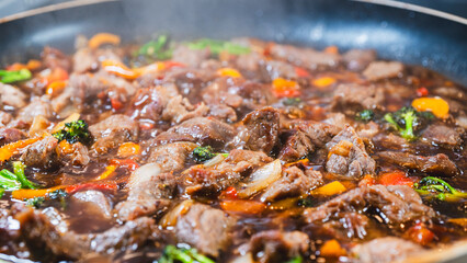 Beef cubes with broccoli, onions, and bell peppers bubbling in savory soy sauce. Smoking hot, perfect for rice bowls or main dish.