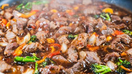 Beef cubes with broccoli, onions, and bell peppers bubbling in savory soy sauce. Smoking hot, perfect for rice bowls or main dish.