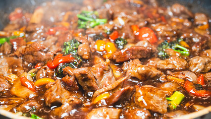 Beef cubes with broccoli, onions, and bell peppers bubbling in savory soy sauce. Smoking hot, perfect for rice bowls or main dish.