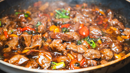 Beef cubes with broccoli, onions, and bell peppers bubbling in savory soy sauce. Smoking hot, perfect for rice bowls or main dish.