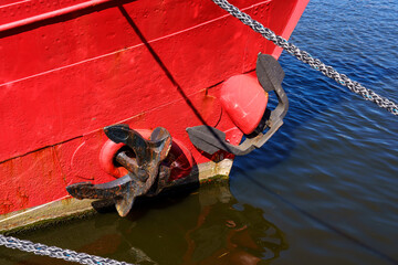 A red boat with a black anchor on it