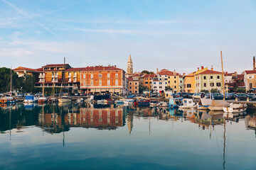 Harborfront Panorama of Izola with Reflections of Boats and Historic Architecture