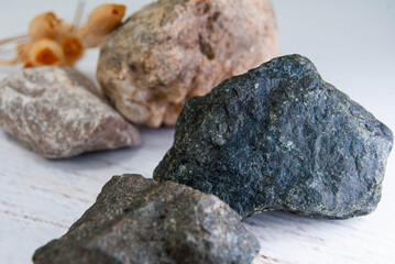Dry flower arranged with colorful decorative stones.